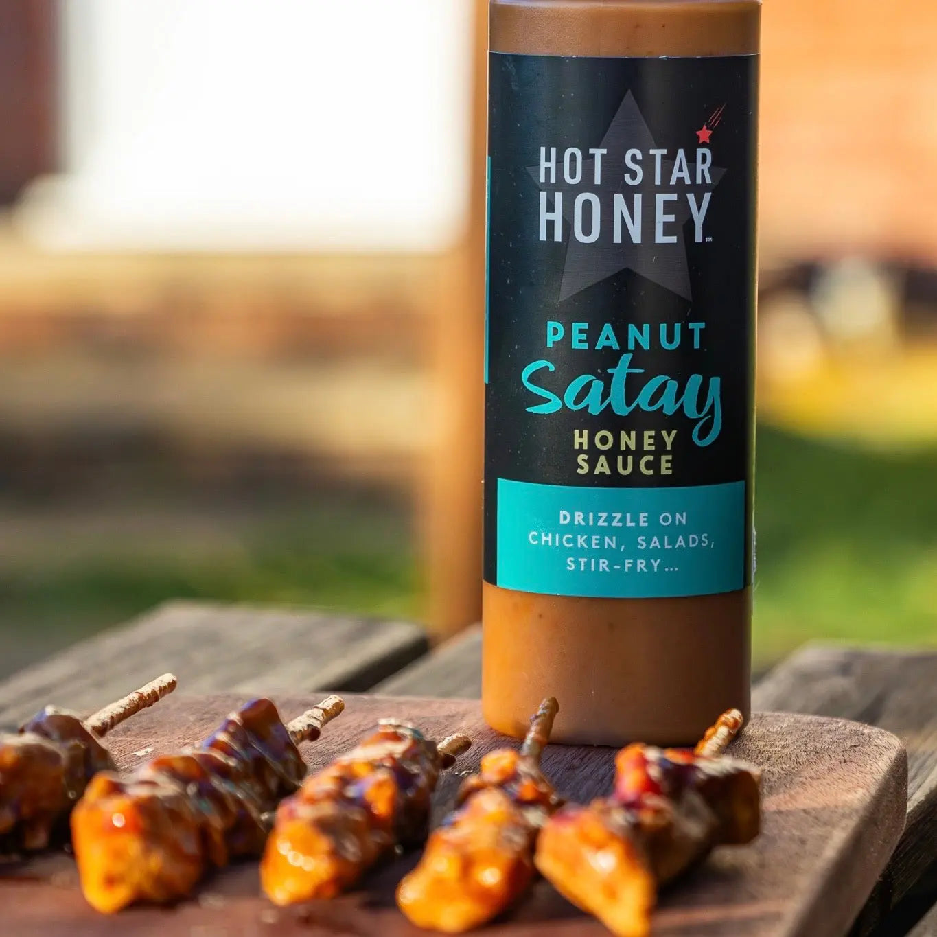 Asian-inspired peanut satay honey sauce from Hot Star Honey served on grilled chicken, showcasing a rich, creamy sauce.