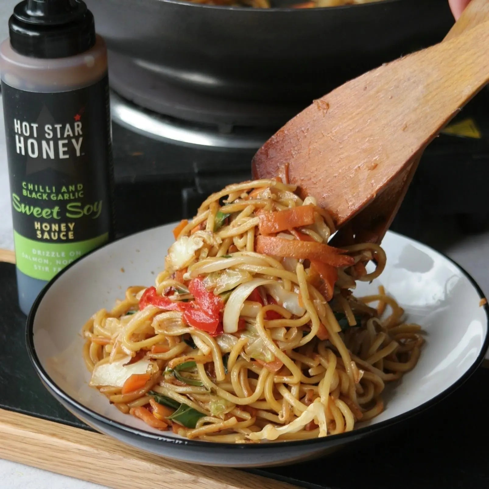 Asian-inspired hot star honey chili and black garlic sweet soy sauce drizzled over stir-fry vegetables.