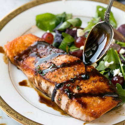 Hot Star Honey Classic Balsamic Honey Glaze drizzled over cooked fish, showcasing its rich, glossy appearance and flavorful finish.