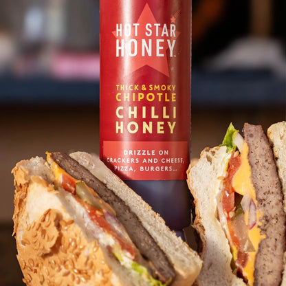 Hot Star Honey chipotle chili honey drizzled on a burger, showcasing its spicy, sweet flavor and rich amber color.