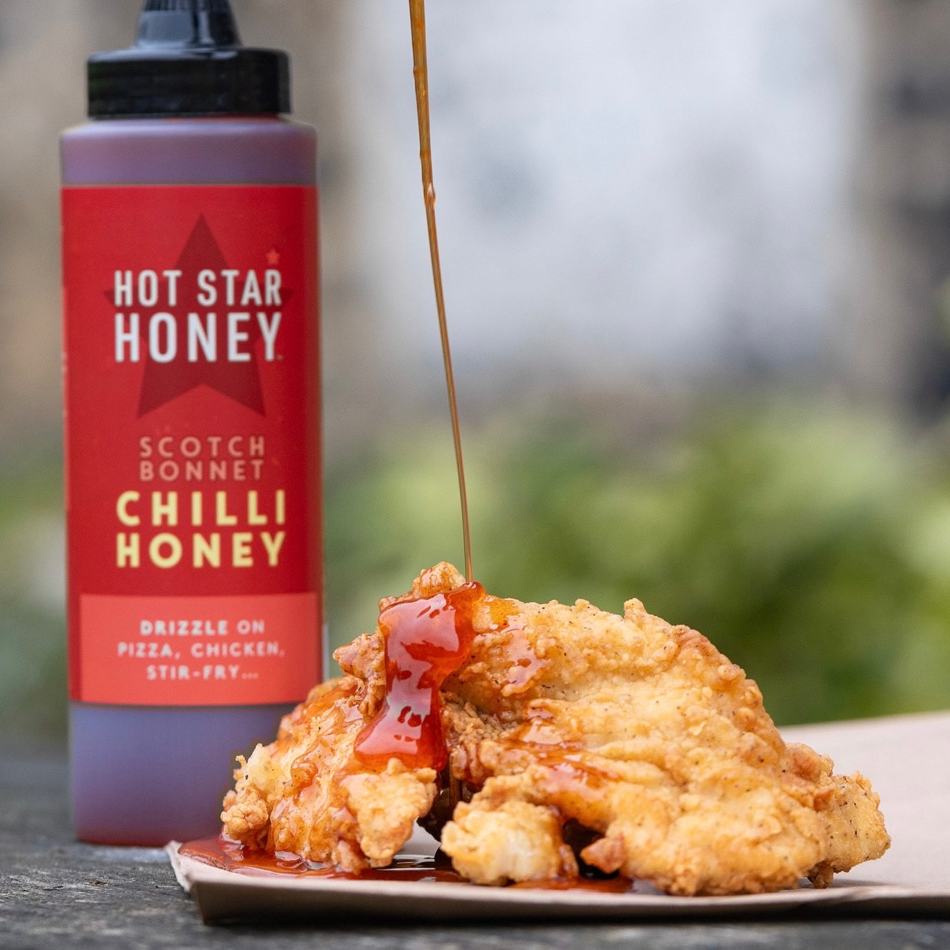 Hot Star Honey Hot Honey Sauce Trio gift set featuring three bottles of spicy honey sauces on a wooden surface.