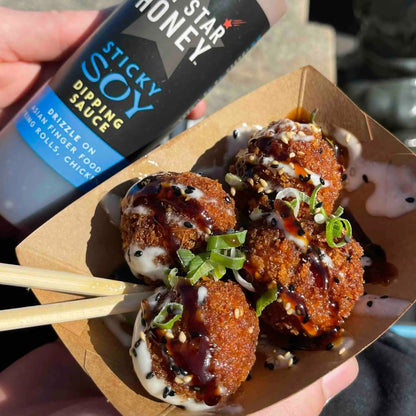 Asian-inspired Hot Star Honey sticky soy dipping sauce served in a small bowl, showcasing its glossy, flavorful appearance.