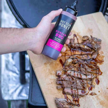 Hot Star Honey Korean BBQ sauce drizzled over grilled steak, showcasing the glossy, flavorful sauce on tender meat.