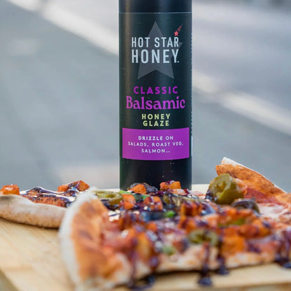 Hot Star Honey Classic Balsamic Honey Glaze drizzled on pizza, showcasing its rich, glossy balsamic flavor and smooth texture.