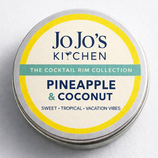 Pineapple and coconut cocktail rim from JoJo’s Kitchen with pineapple and coconut pieces on a decorative serving.