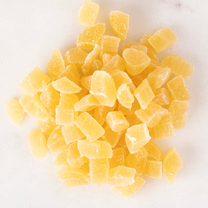 Dried pineapple chunks from Whole Food Earth, diced and golden, ideal for snacking or baking.