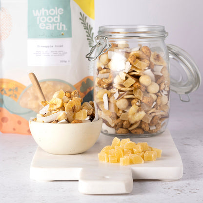 Dried pineapple diced pieces from Whole Food Earth, showing golden-yellow chunks of dried pineapple on a neutral background.