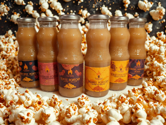 Six cold brew coffee bottles inspired by popcorn flavors from Ignite Coffee Co, arranged in a cozy setting.