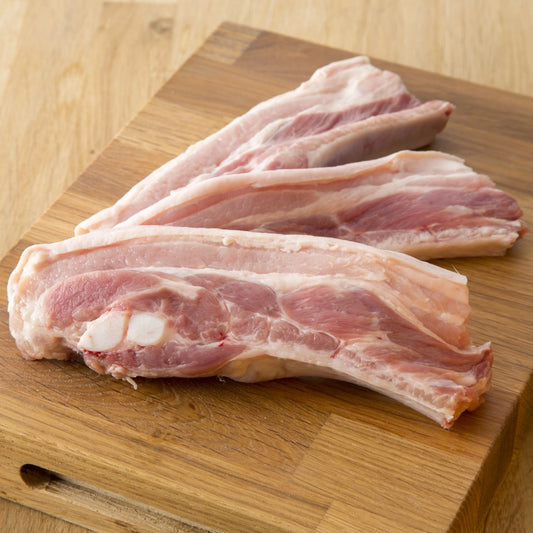 Primrose Herd pork belly slices, thinly sliced pork belly meat ideal for roasting or grilling, on a clean white background.