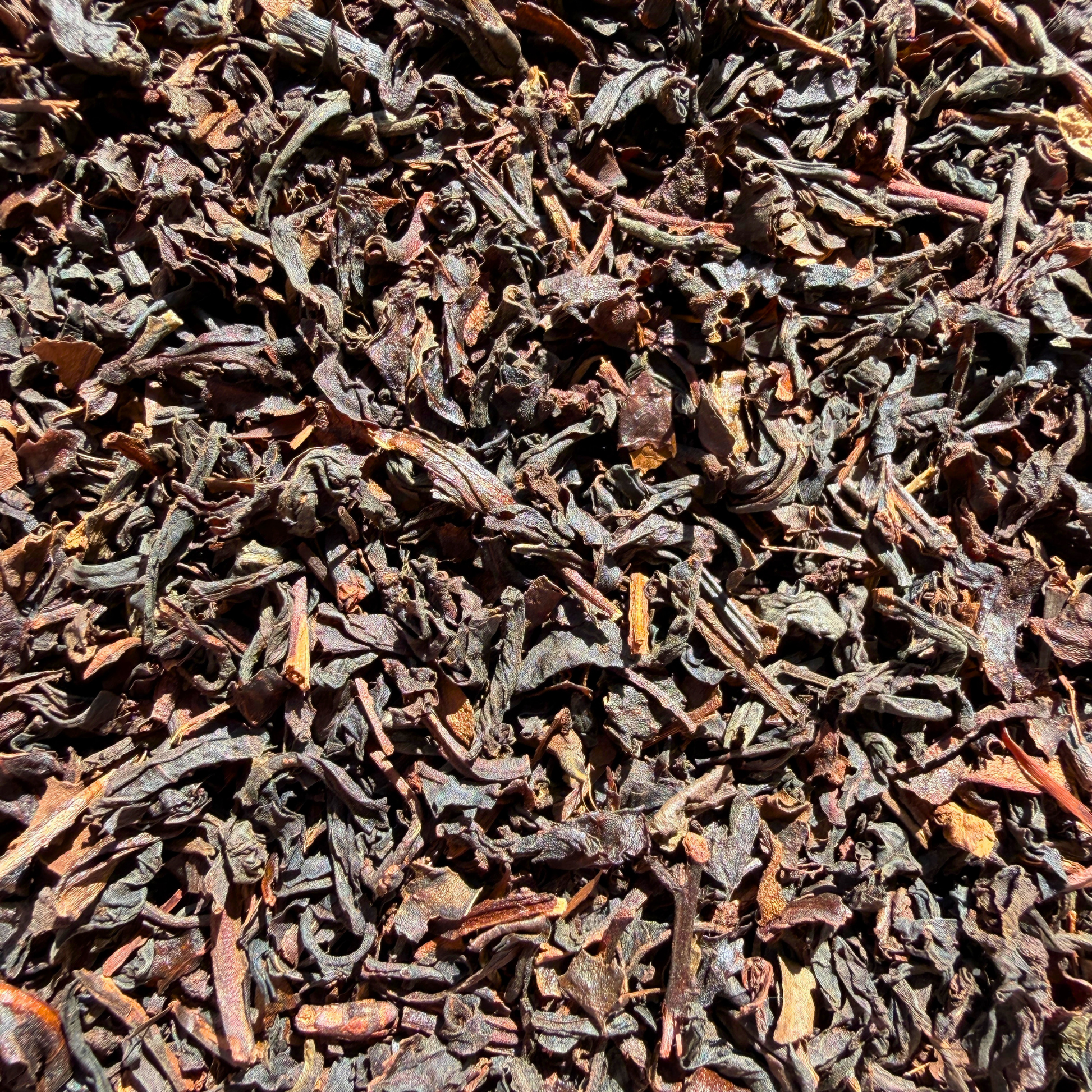 Loose leaf Formosa Oolong tea from Porter Hill Tea Company, showcasing twisted, dark amber leaves with a rich aroma.
