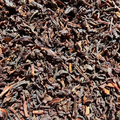 Loose leaf Formosa Oolong tea from Porter Hill Tea Company, showcasing twisted, dark amber leaves with a rich aroma.