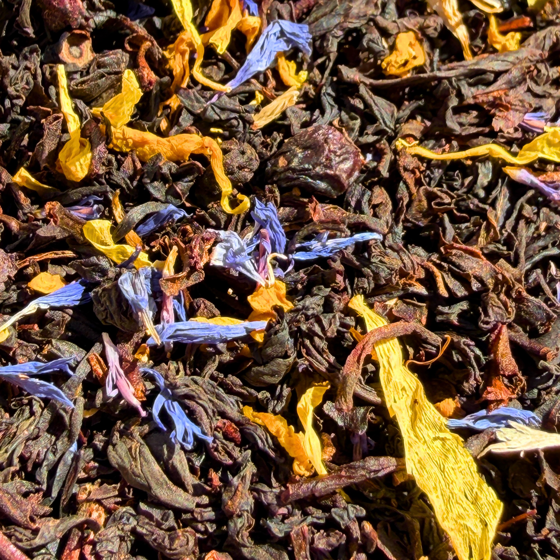 Porter Hill Black Tea with Blueberry and Maple, loose leaf tea in a clear container showing dark tea leaves with berry and maple accents.