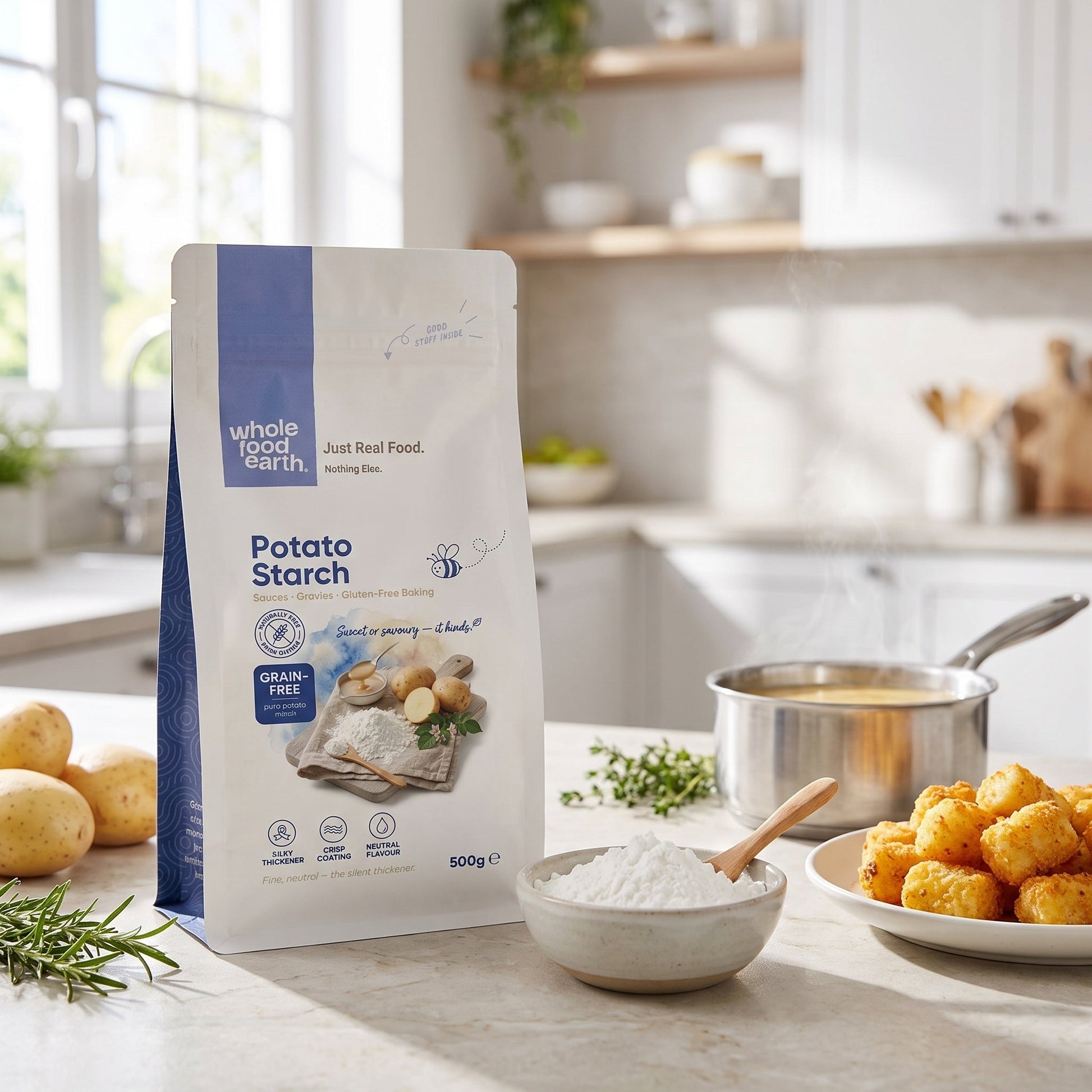 Whole Food Earth potato starch in 500g package, shown in a kitchen setting with baking ingredients and utensils.