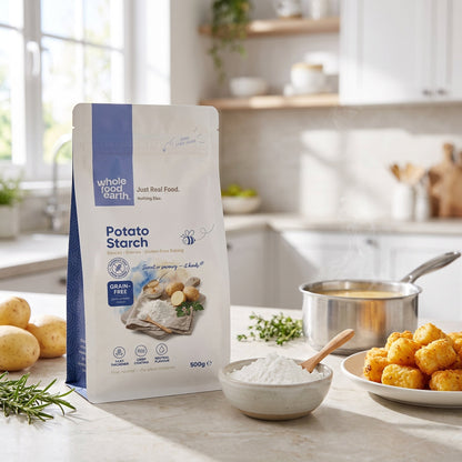 Whole Food Earth potato starch in 500g package, shown in a kitchen setting with baking ingredients and utensils.