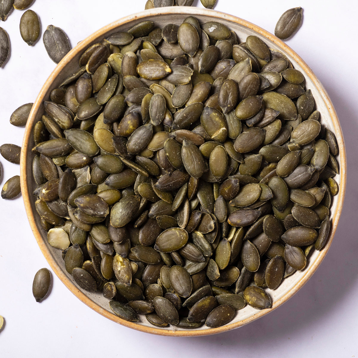Whole Food Earth pumpkin seeds, a nutritious nut and seed snack, shown in a close-up image highlighting their green and tan shells.