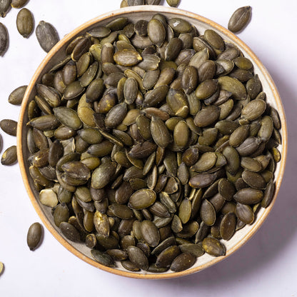 Whole Food Earth pumpkin seeds, a nutritious nut and seed snack, shown in a close-up image highlighting their green and tan shells.