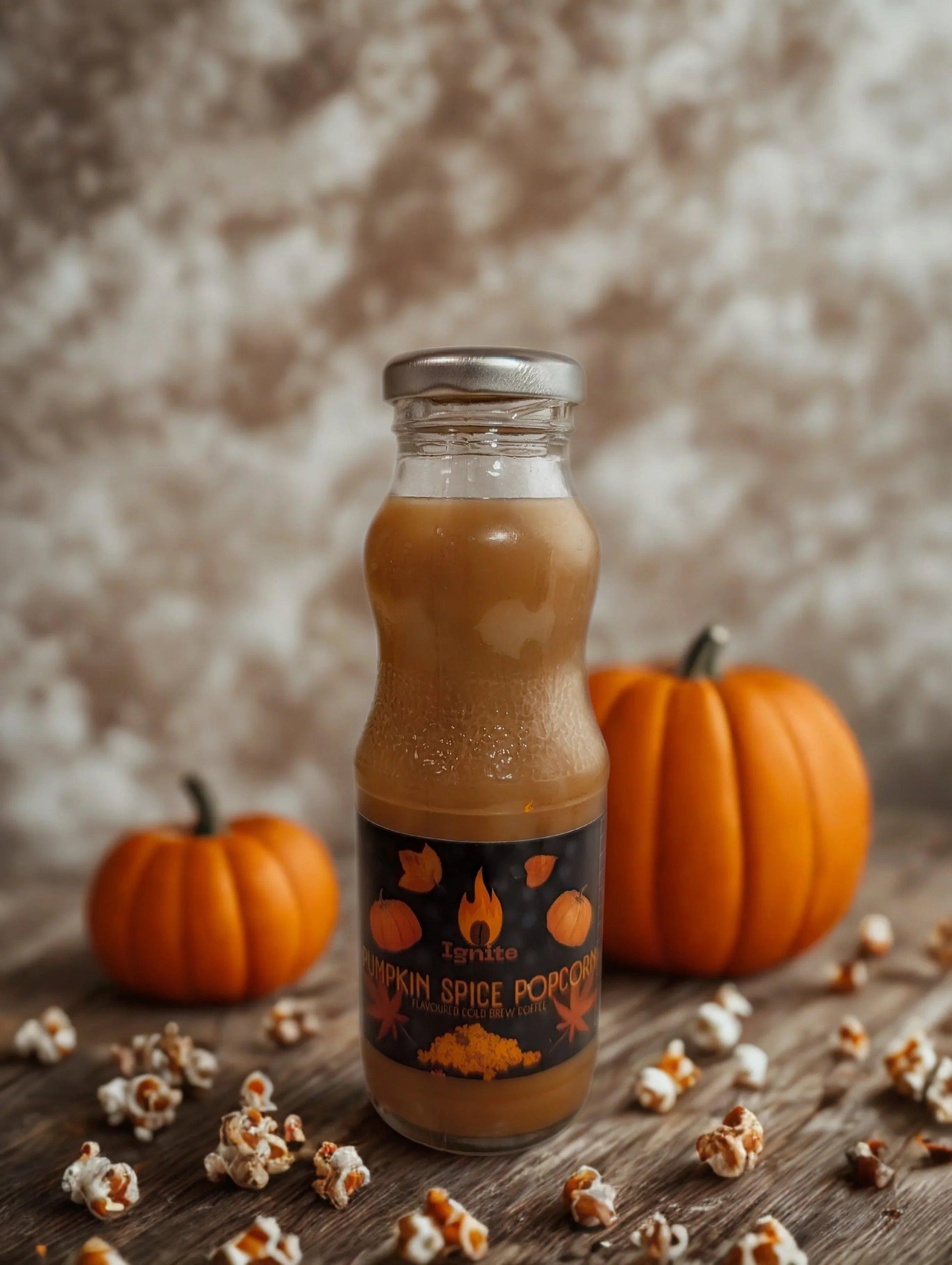 Warm-colored cold brew pack with popcorn and pumpkin spice flavor from Ignite Coffee Co, perfect for cozy moments.