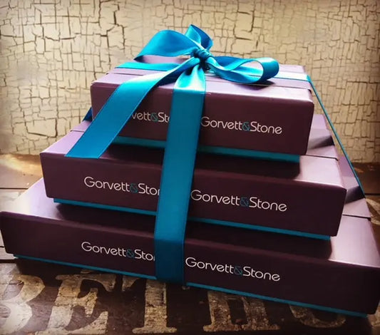 Three-tier pyramid of Gorvett & Stone boxes arranged in a pyramid shape, showcasing elegant packaging and sturdy construction.