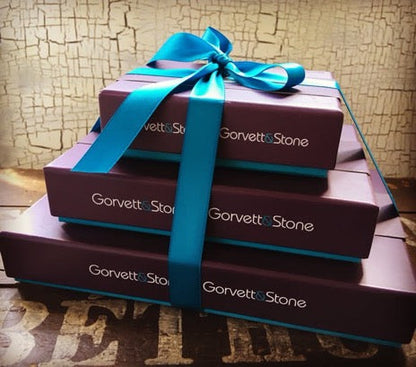Assorted chocolate gift box featuring oranges and lemons, presented in a pyramid arrangement by Gorvett & Stone.