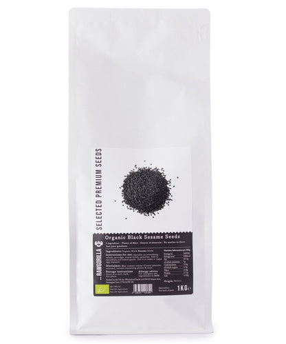 Organic black sesame seeds from RAWGORILLA in a 1kg package, shown in a close-up of the seed pile.