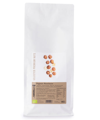 Organic hazelnuts from RAWGORILLA in a 1kg package, shown in a close-up view with whole, raw hazelnuts and shell details.