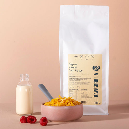 Organic natural corn flakes cereal from RAWGORILLA in 500g package, whole food earth brand, with crispy golden flakes visible.