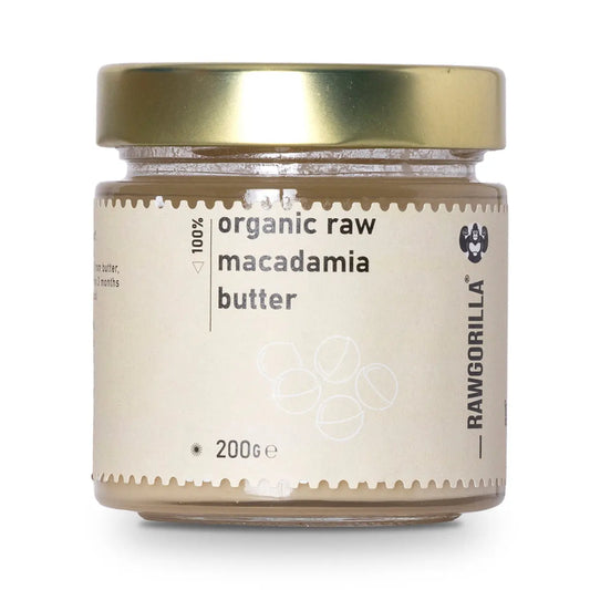 Creamy organic raw macadamia nut butter from RAWGORILLA, in a jar, showcasing smooth texture and natural nut appearance.