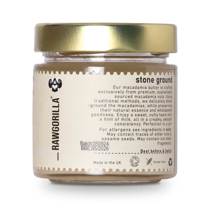 Organic raw macadamia butter from RAWGORILLA in a jar, showcasing a creamy, light-colored nut butter on a wooden surface.