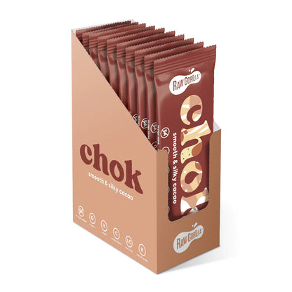 Open Chok Smooth & Silky Cacao Bar by Raw Gorilla showing creamy chocolate interior in a natural setting.