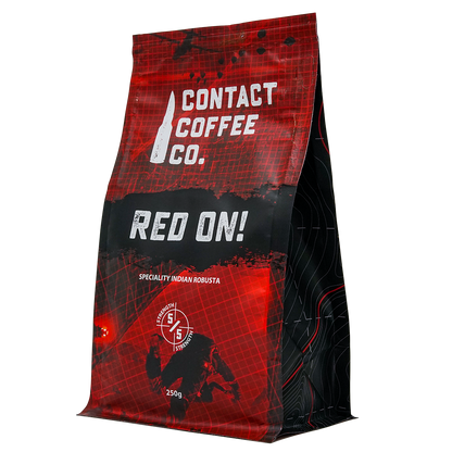 Assorted coffee beans and packaging from Contact Coffee Company Ltd. for coffee resupply deals, displayed in a natural setting.