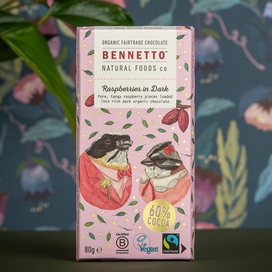 Dark chocolate with fresh raspberries from Bennetto Natural Foods UK, shown broken open to reveal ripe raspberries inside.