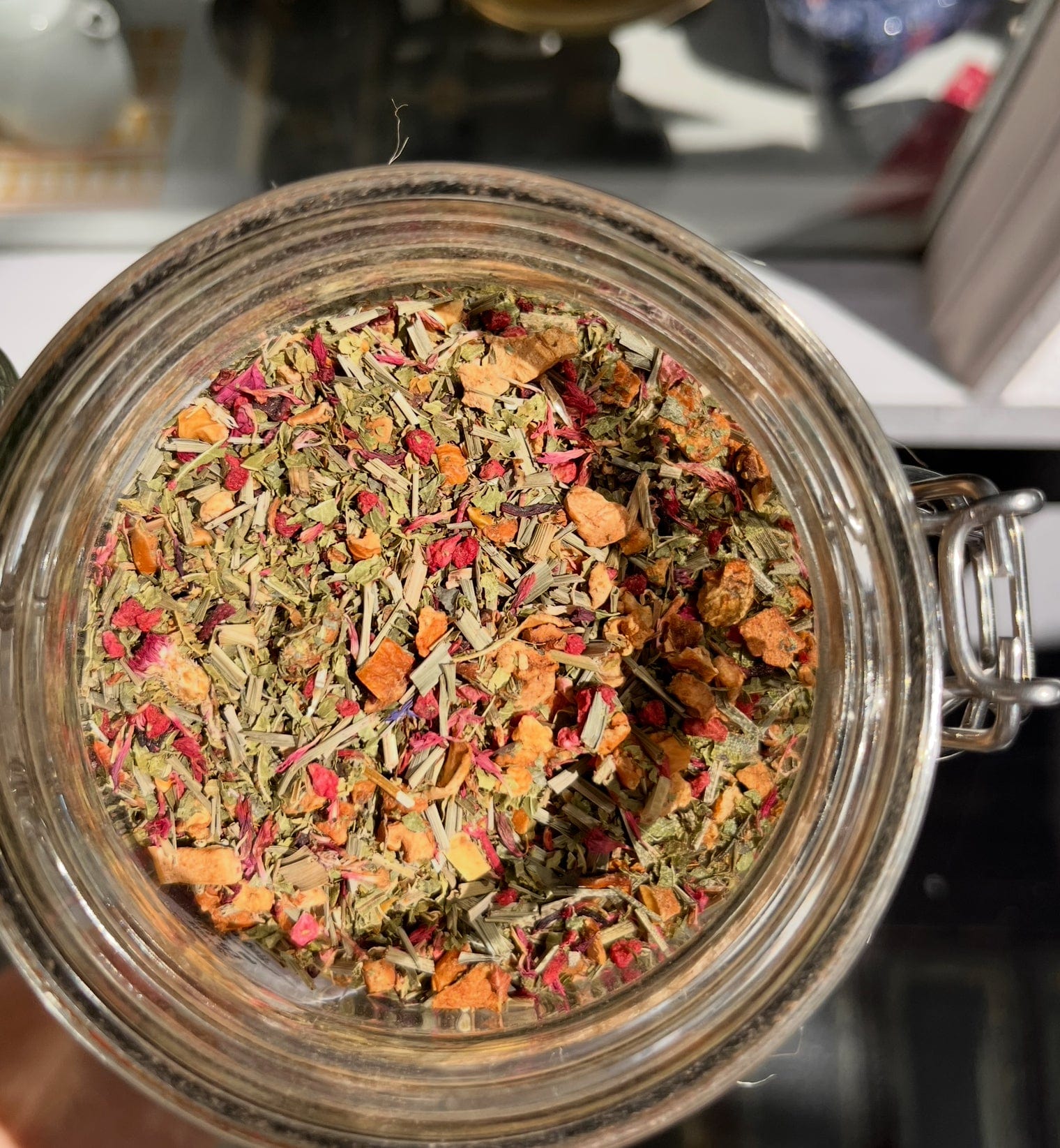 Porter Hill Tea Company's Raspberry Lemon Verbena herbal tea in a clear glass mug with fresh raspberry and lemon slices.