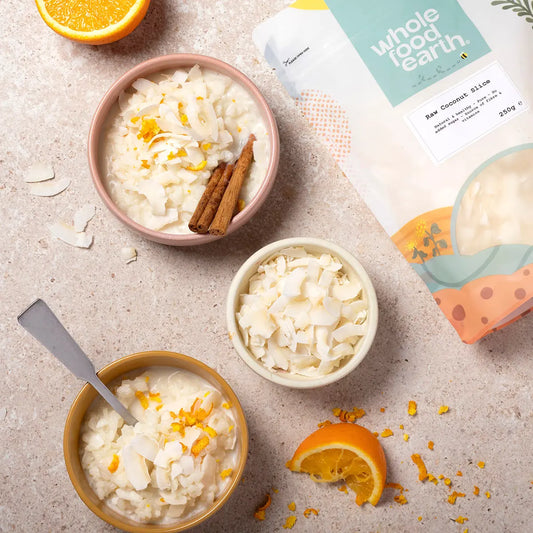 Raw coconut slice from Whole Food Earth, dried fruit with textured, natural coconut pieces on a rustic wooden surface.