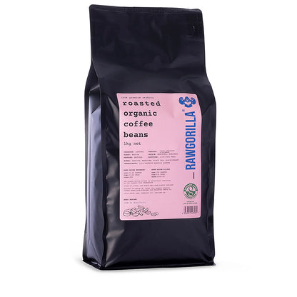 Roasted organic whole coffee beans from RawGorilla, 1kg, by Whole Food Earth, showcasing glossy brown beans in a natural setting.