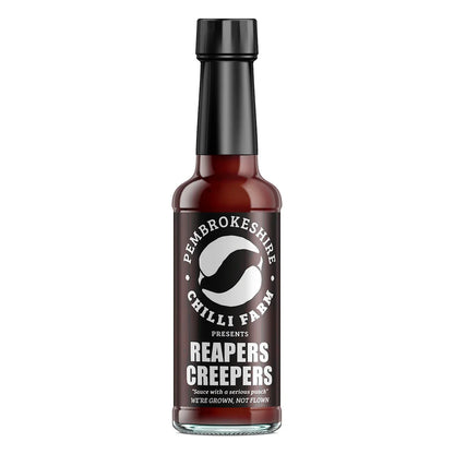 Reapers Creepers hot chilli sauce bottle from Pembrokeshire Chilli Farm with label and vibrant red sauce in clear glass bottle.