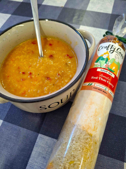 Crafty Cook Easy Meals starter plan features a bowl of vibrant red Thai curry soup with fresh herbs and vegetables.