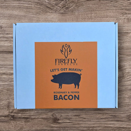 FireFly Barbecue Bacon Curing Kit with rosemary and black pepper, includes ingredients and tools for homemade bacon curing.