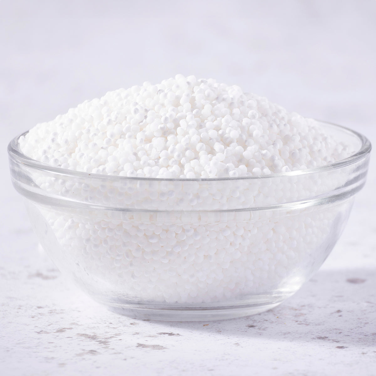Whole Food Earth sago pearls, small translucent tapioca-like grains used in cooking and baking, displayed in a close-up image.