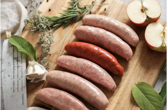 Primrose Herd chorizo sausages arranged on a plate, showcasing their spicy, seasoned appearance and natural casing.