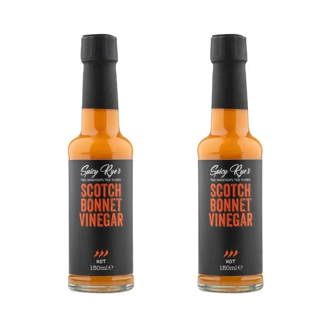 Two bottles of Spicy Ryes Scotch Bonnet Vinegar with red caps and clear labels, showcasing the spicy vinegar product.