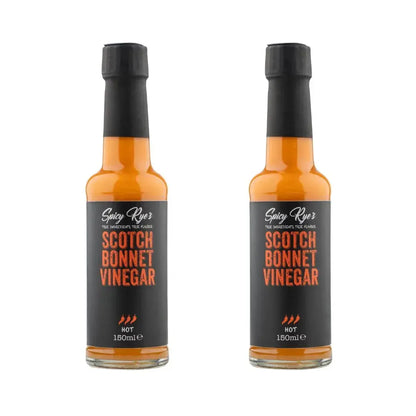 Two bottles of Spicy Ryes Scotch Bonnet Vinegar with red caps and clear labels, showcasing the spicy vinegar product.