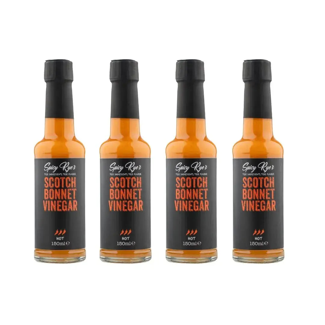 Spicy Ryes Scotch Bonnet Vinegar bottles, bright yellow and red labels, showing four 710ml bottles of hot pepper vinegar.