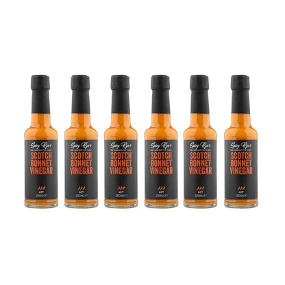 Six bottles of Spicy Ryes Scotch Bonnet Vinegar with red caps and label, arranged in a row on a white background.
