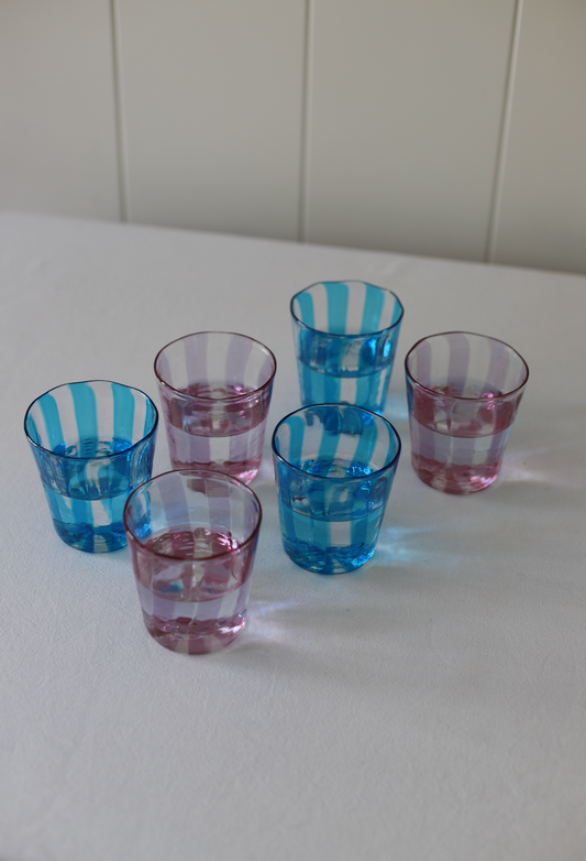 Set of four turquoise Giorgio tumblers by domenicamarland, showcasing sleek, modern glassware with a smooth finish.