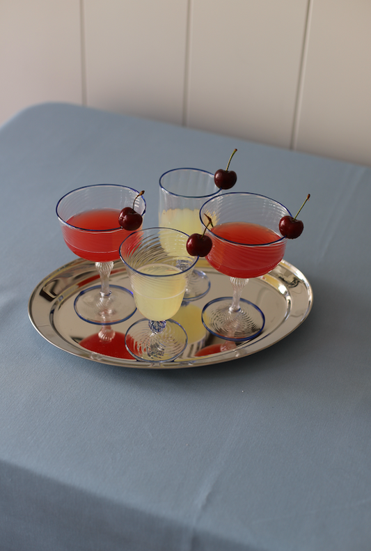 Set of two Domenicamarland Dido Venetian wine glasses in blue with elegant, handcrafted glass design on a clear background.