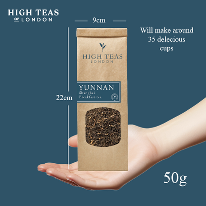 Loose leaf Yunnan Imperial "Gold Tip" Shanghai Breakfast Tea by High Teas, showing golden-tipped tea leaves in a clear container.