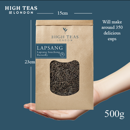 Loose leaf Lapsang Souchong butterfly tea by High Teas, showing dark, twisted tea leaves in a clear glass jar.