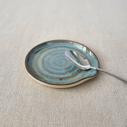 Seafoam blue ceramic spoon rest by Katie L Thompson Designs, with a classic, smooth design ideal for kitchen use.