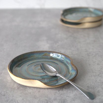 Seafoam blue ceramic spoon rest with a classic design by Katie L Thompson Designs, ideal for kitchen countertop use.