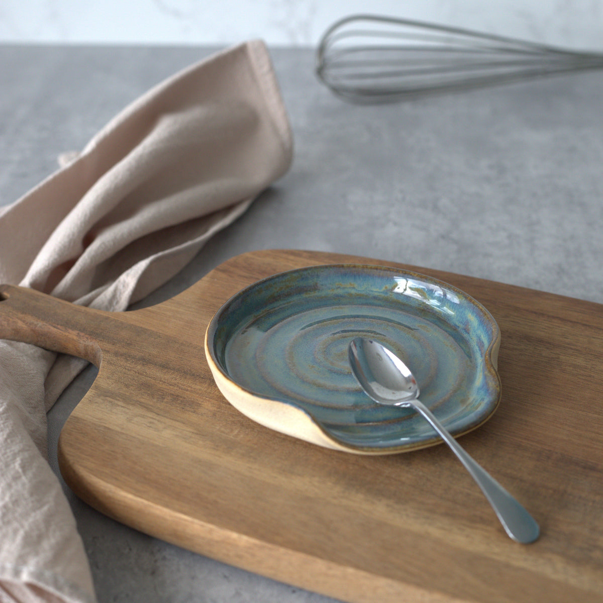 Seafoam blue ceramic spoon rest by Katie L Thompson Designs, featuring a classic, elegant shape for kitchen use.